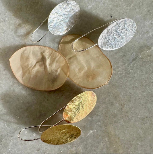 HONESTY HOOKS: handmade from sheets of recycled silver and brass, these earrings are honesty seed shaped on recycled silver hook wires. Hand hammered for texture to catch the light.