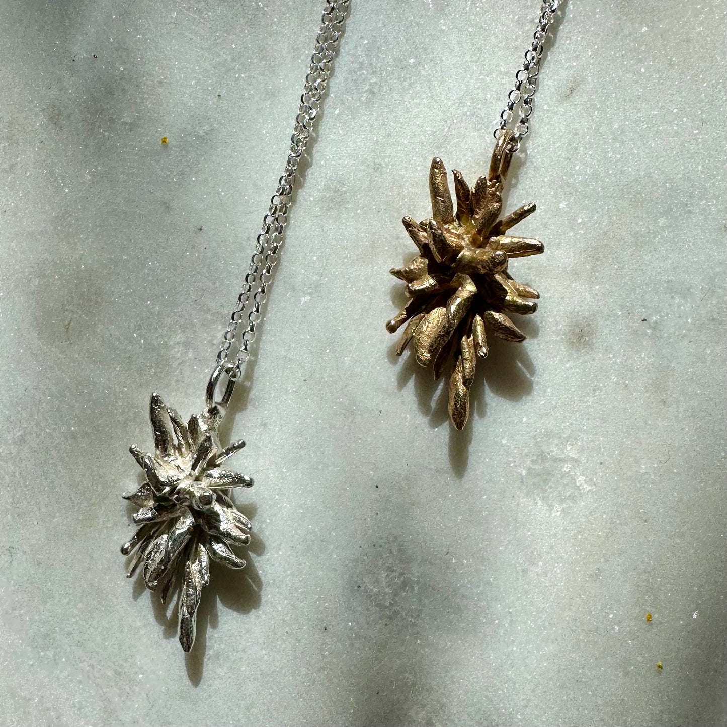 DEW OF THE SEA NECKLACE: softly spiky sea rosemary charms in recycled brass and recycled silver hang from recycled silver chains.