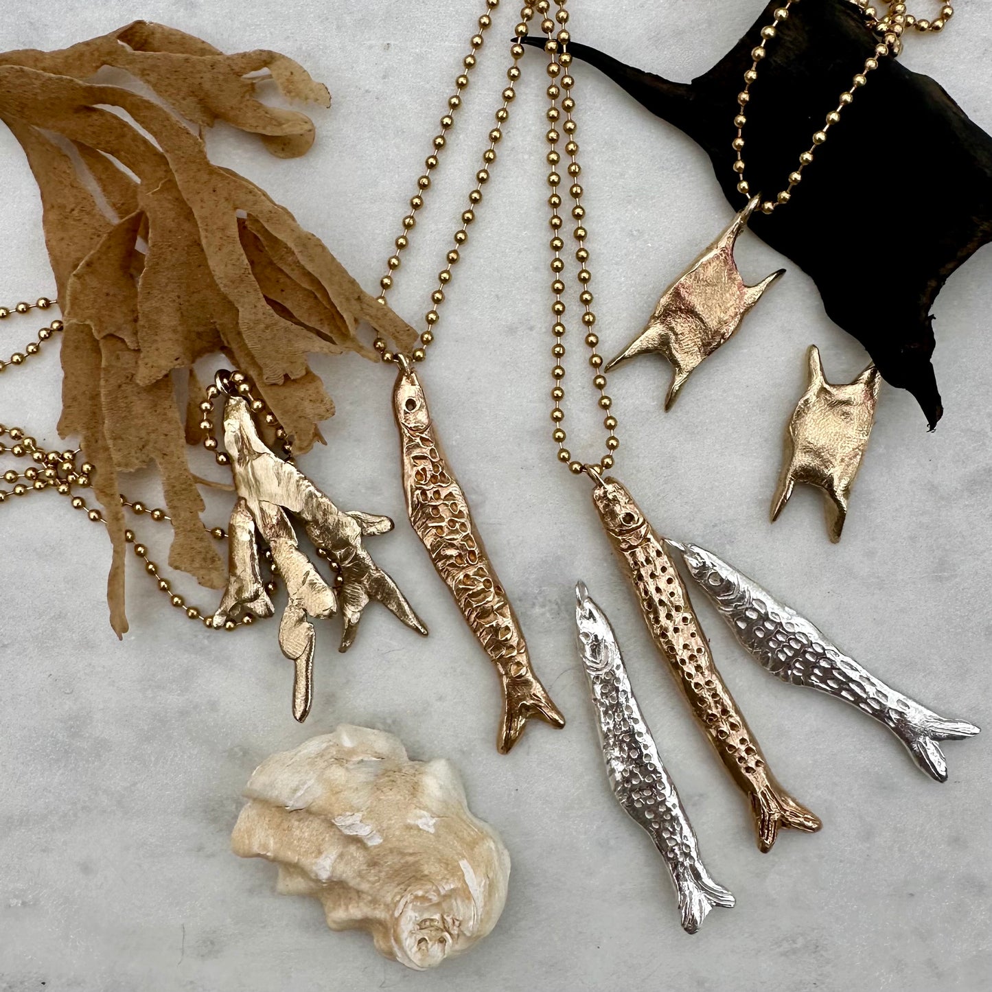 A weird and wonderful mermaid's purse shaped brass pendant on a long brass ball chain. Handmade in recycled brass.