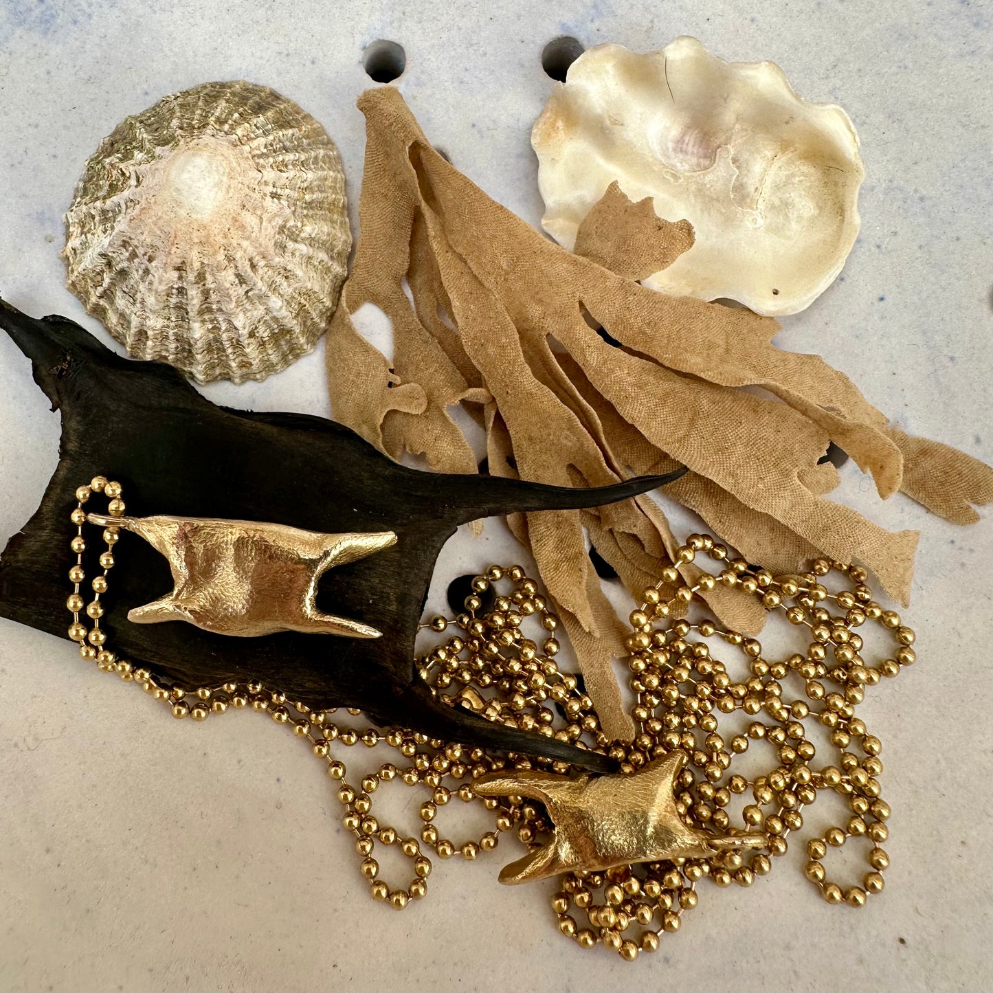 A weird and wonderful mermaid's purse shaped brass pendant on a long brass ball chain. Handmade in recycled brass.