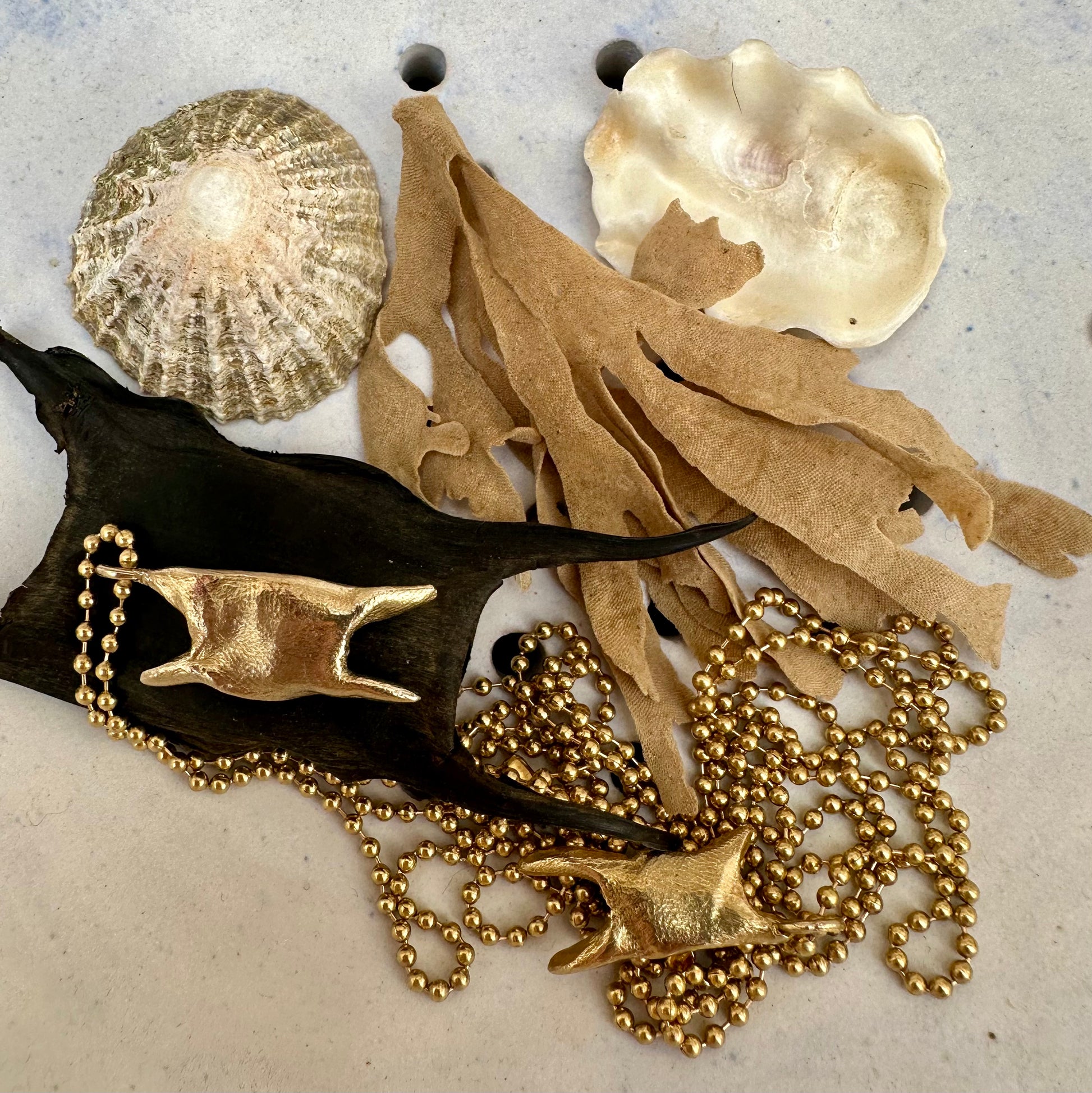 A weird and wonderful mermaid's purse shaped brass pendant on a long brass ball chain. Handmade in recycled brass.