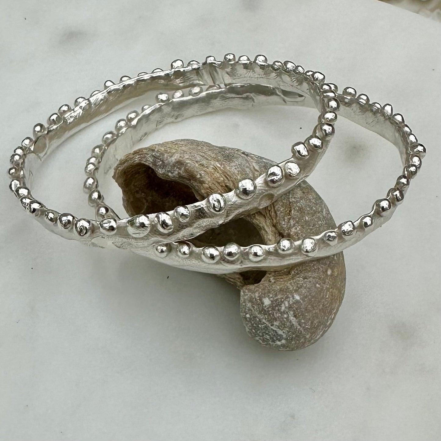 Beautiful bobble edged bangles reminiscent of the frilly bobbly edged kelp seaweed. Handmade in wax and cast in recycled silver.