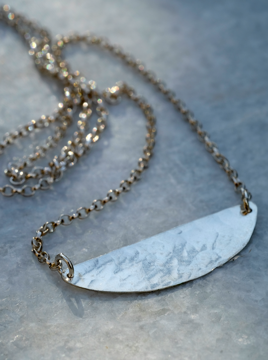 Ida Necklace: an eye catching but simple necklace with a recycled, hammered silver segment shape on a recycled silver belcher chain.