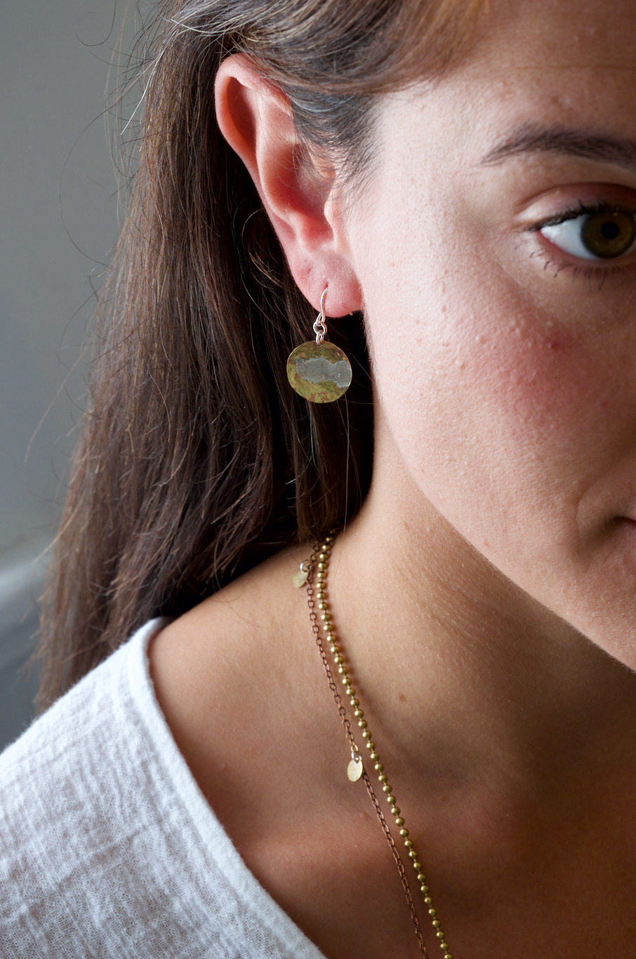 Brass and Silver Moon Earrings: handmade brass disc with swirling recycled silver surface decoration.