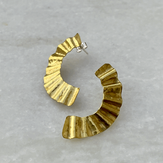 Handmade recycled brass earrings reminiscent of the rippling surface of a breeze across water, these studs have both rippling forms and curving shapes.