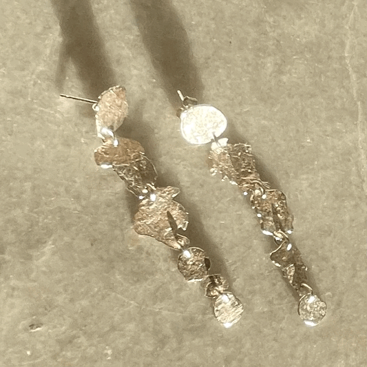 Ponds Earrings: handmade from melting recycled silver into five articulated pond shapes that move as you do.
