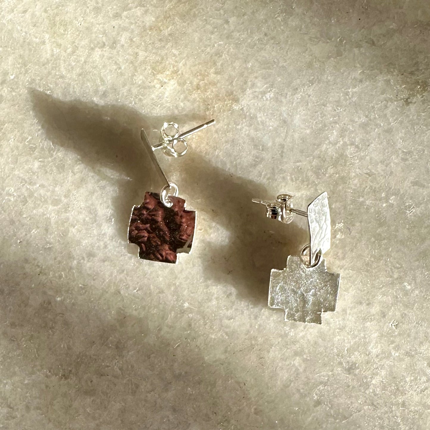 Nell Earrings: gorgeous handmade recycled silver earrings of rectangular and cross shapes. Articulated for movement and to benefit from that inimitable flash of silver. Worn by a model.