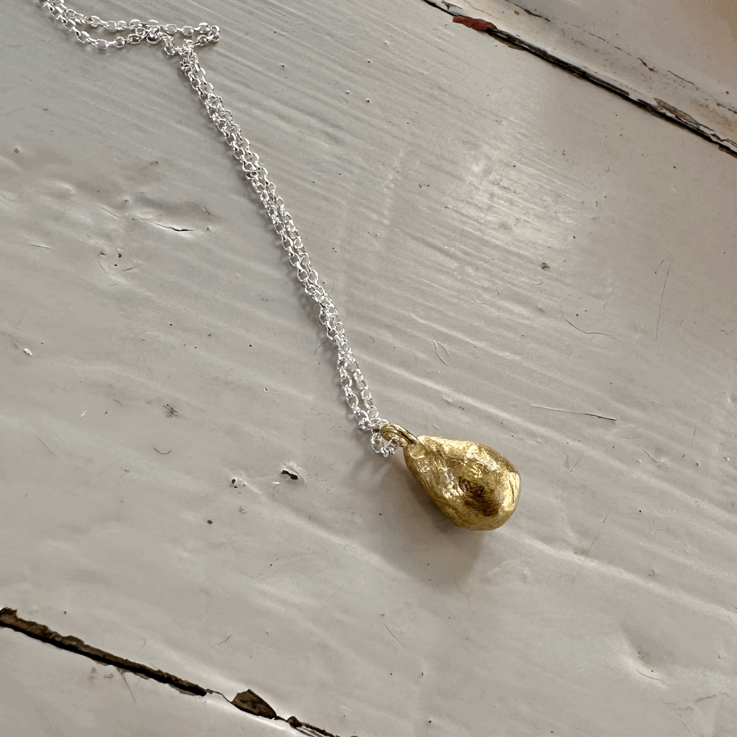 Pearly Dew Drop Necklace: A sweet little drop of solid recycled brass on a recycled silver chain.