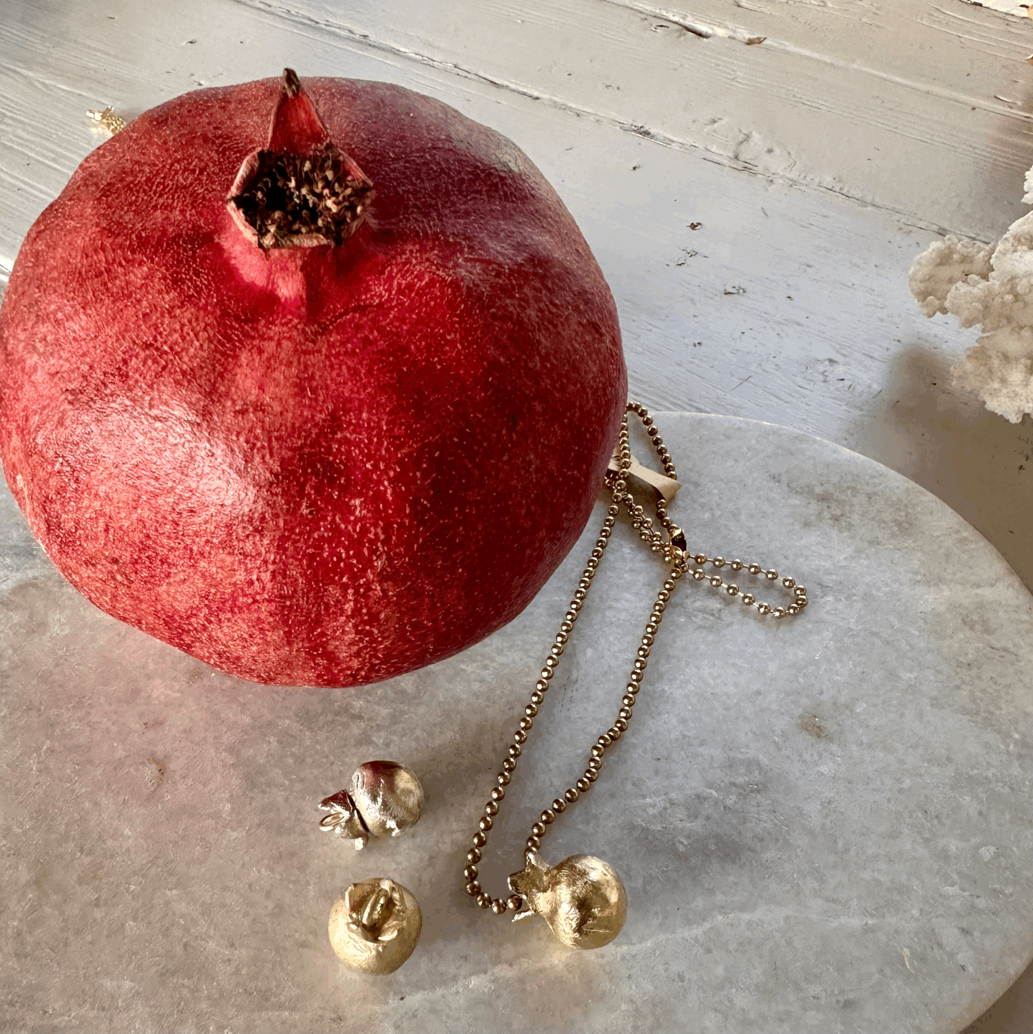 Pomegranate Pendant: A solid recycled brass pomegranate charm on a long brass ball chain.