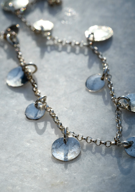 Rose Necklace: a handmade necklace featuring tiny discs of hammered recycled silver hanging from a recycled silver chain.