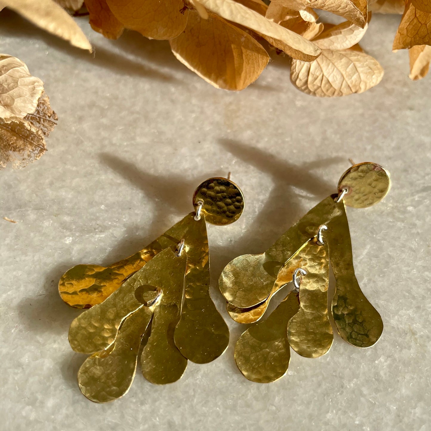 Sadie Earrings: handmade from recycled brass sycamore inspired abstract shapes hang and sway from a brass disc.