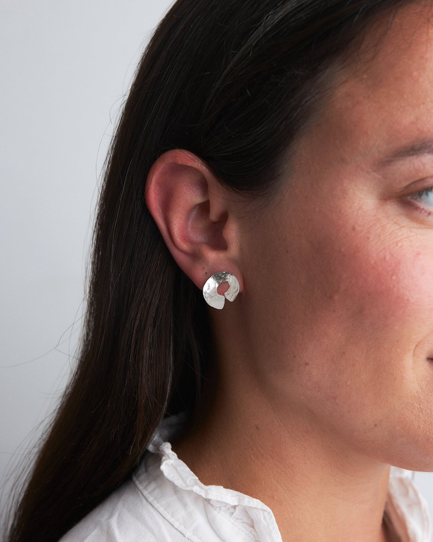 Codium Studs: handmade earrings in recycled silver, based on the shape of the ends of codium seaweed. Worn by a model.