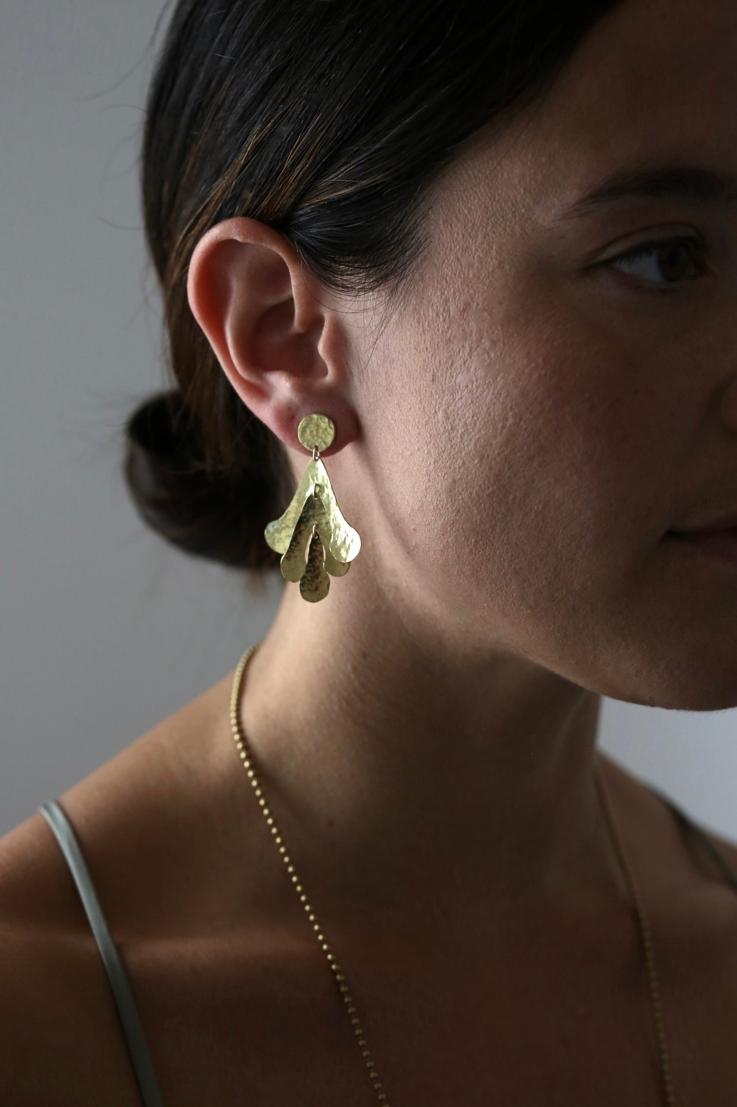 Sadie Earrings: handmade from recycled brass sycamore inspired abstract shapes hang and sway from a brass disc.