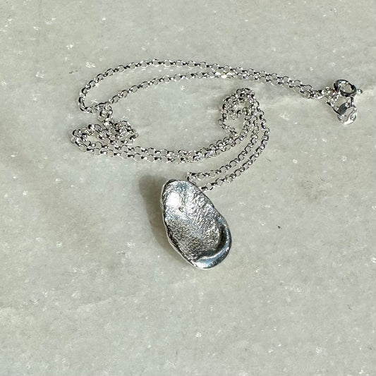 Droplet Necklace: a cast droplet of solid recycled silver on a recycled silver chain.