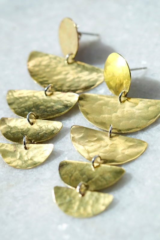 Bella Earrings: handmade with four graduated half moon shapes in recycled brass hanging from a brass disc.