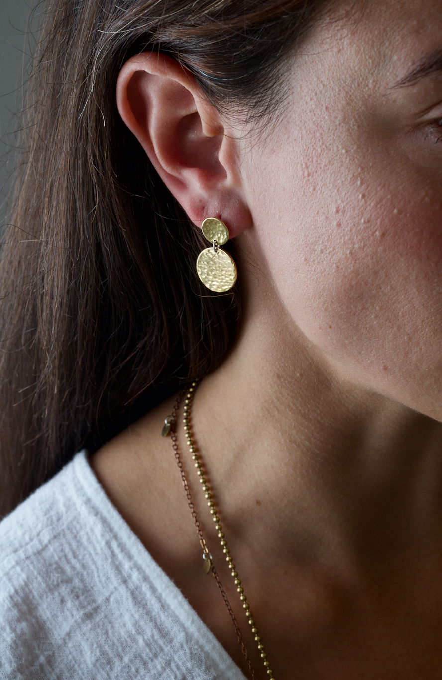 Brass Double Disc Earrings: striking but simple handmade recycled brass earrings. Worn by a model.