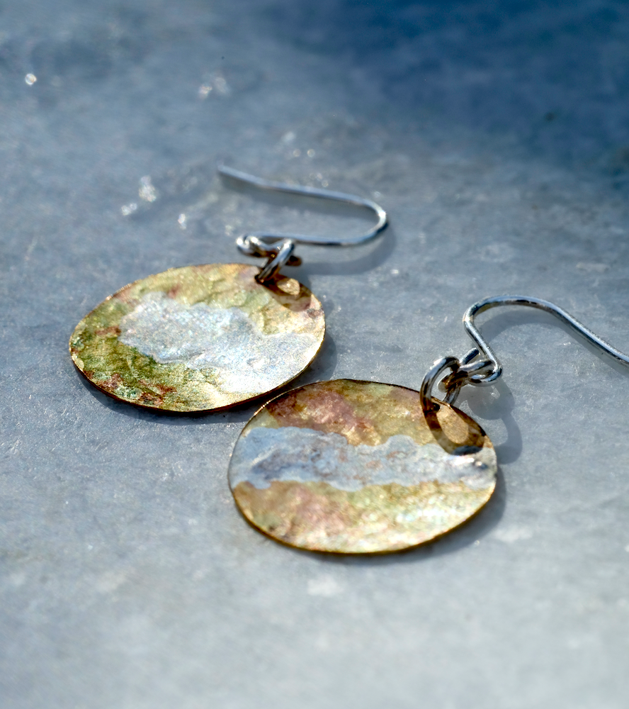 Brass and Silver Moon Earrings: handmade brass disc with swirling recycled silver surface decoration.