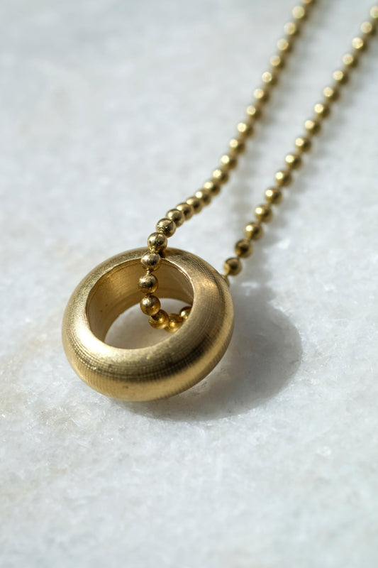 Delilah Pendant: a gorgeous handmade pendant with a tactile weighty solid brass ring on a vintage brass ball chain - strikingly simple.