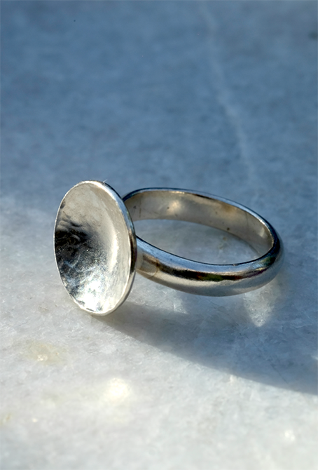 Silver Moon Ring: a lovely chunky ring handmade from recycled silver with a slightly concave domed and hammered disc on a solid recycled silver ring shank. Inspired by the moon.