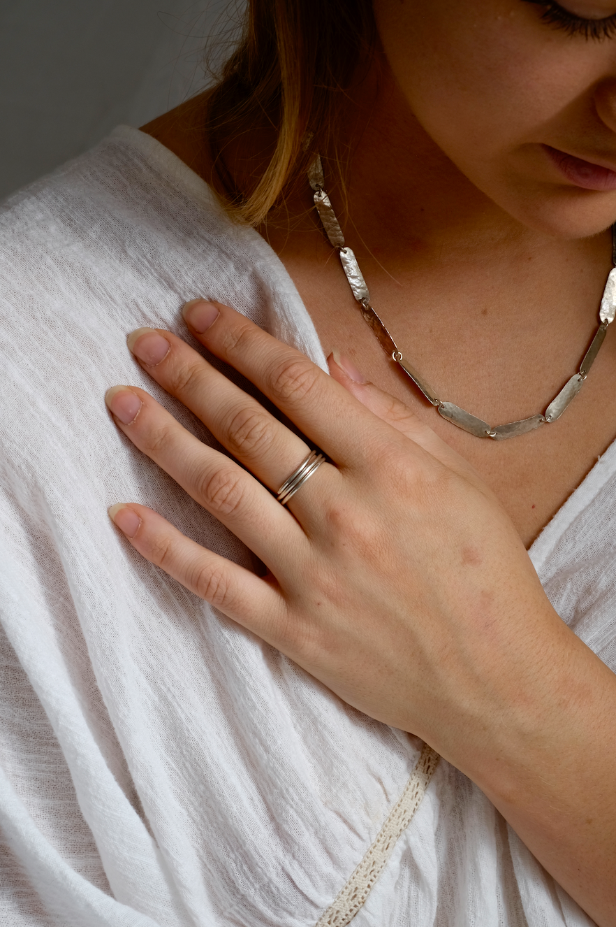 Silver Smooth Spiral Ring: a simple ring consisting of a spiral of smooth recycled silver. Worn by a model.