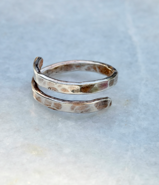 Hammered Silver Spiral Ring: a thicker and textured spiral ring with rounded ends: a spiral of hammered 2.5mm wide recycled silver. Handmade sustainably in Suffolk.